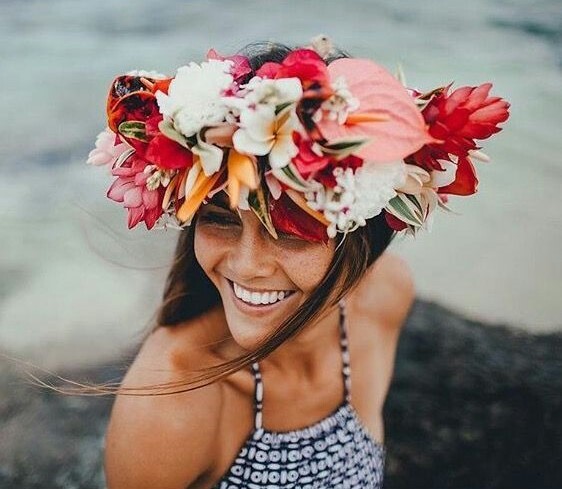 Happy person on the beach with flowers in their hair
