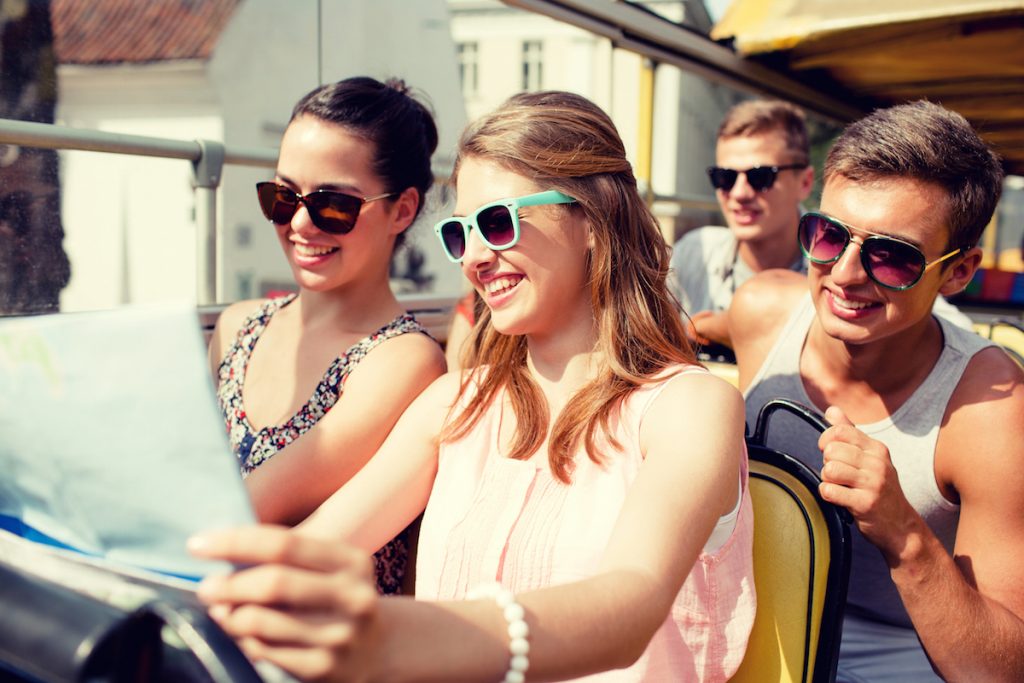 Tourists on double decker bus looking at a map