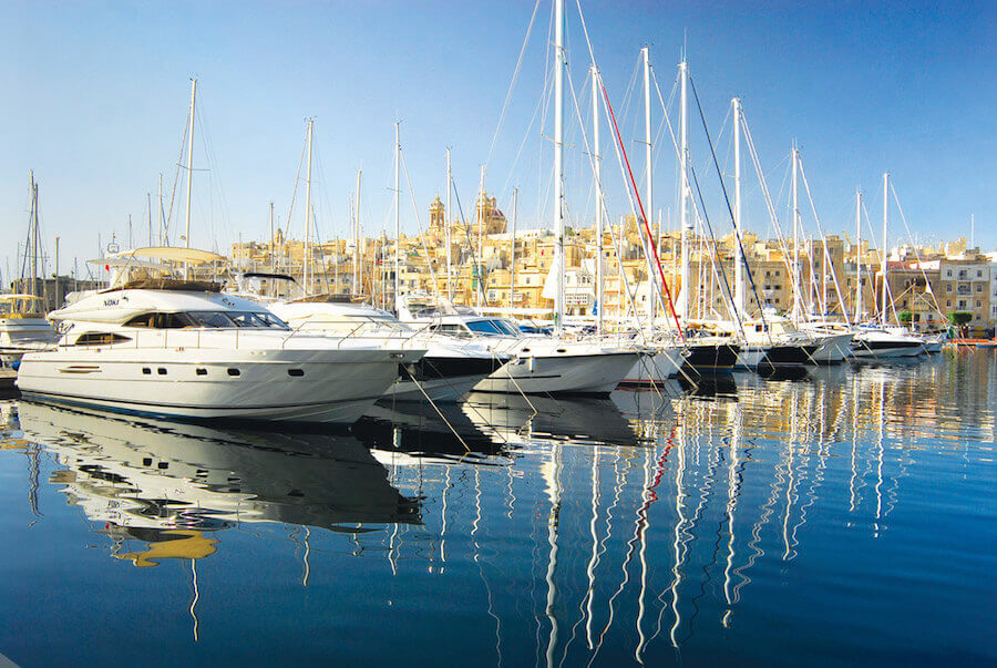 yachts and boats moored in a large marina