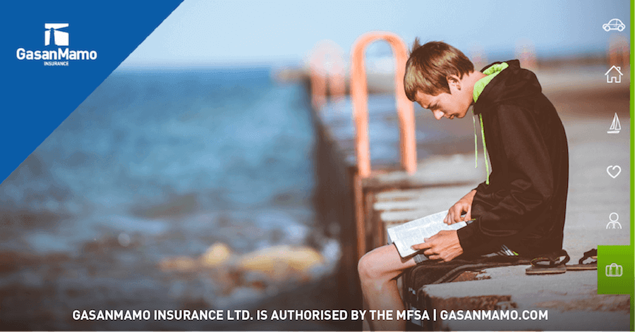 Boy reading by the sea