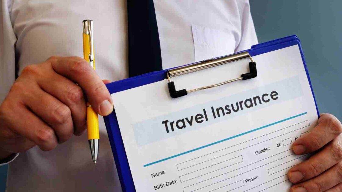 Travel insurance papers on desk with miscellaneous items