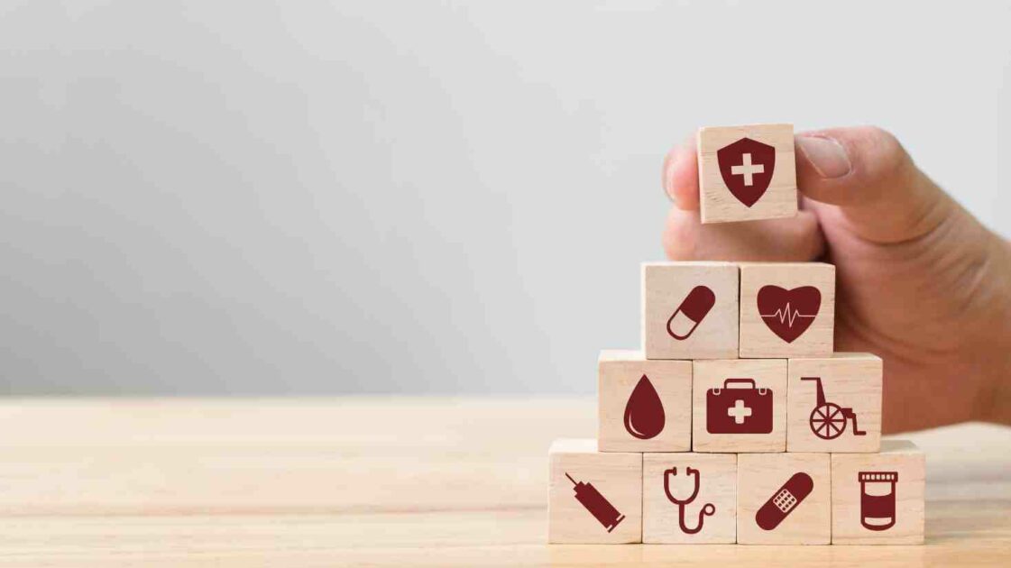 WOODEN BLOCKS IMAGE OF HEALTH CARE RELATED SYMBOLS, Why Take Out Private Health Insurance