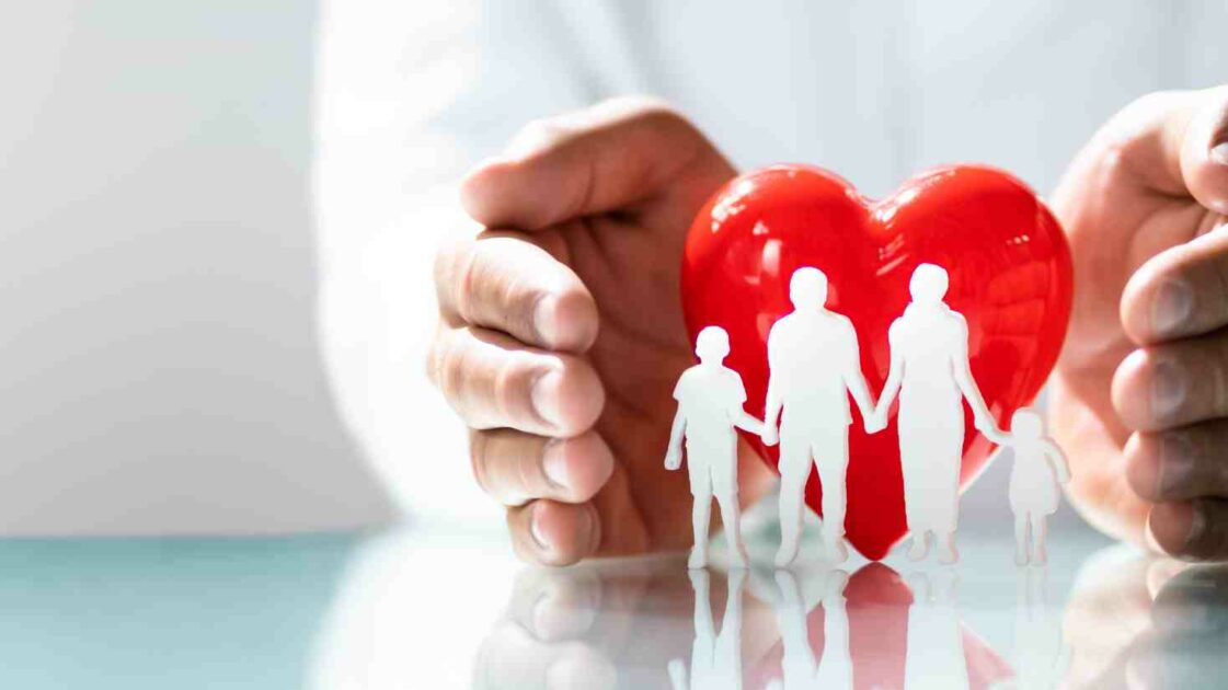 Doctor holding a family of hearts to signify health insurance, Explained: What is Health Insurance