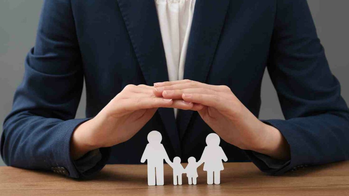 Hands covering a family, What Does Health Insurance Cover? GasanMamo