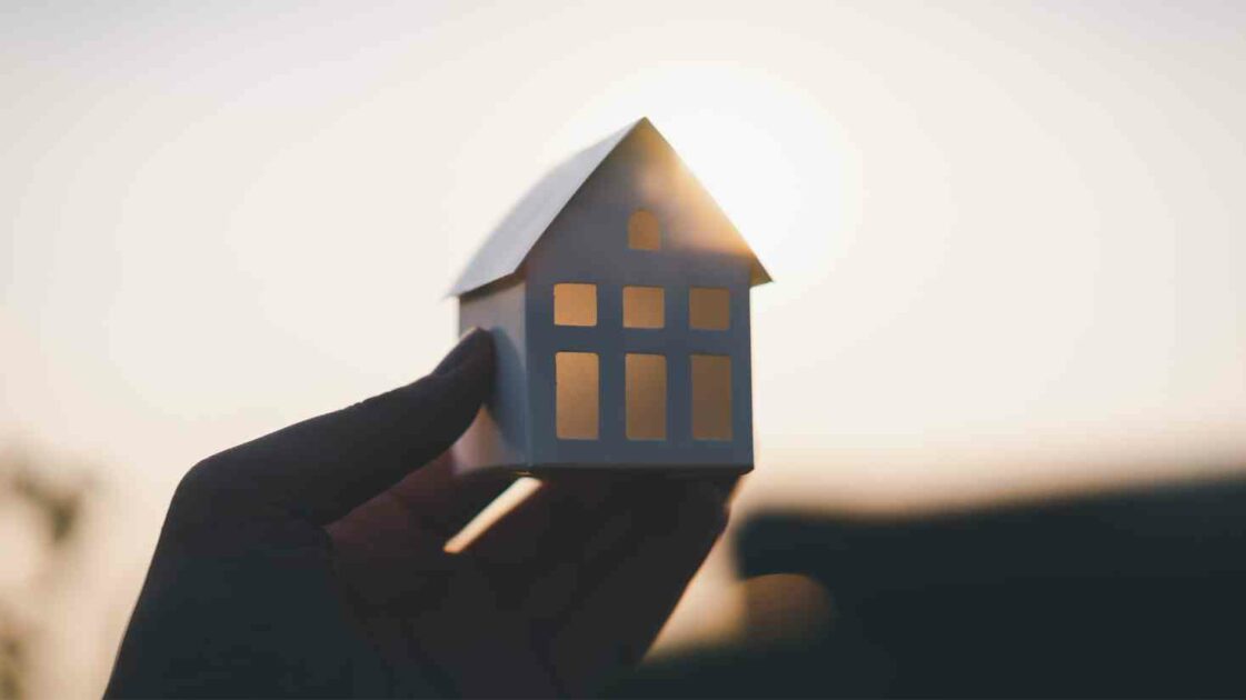 Image of someone holding up a house, Does Home Insurance Cover Structural Damage